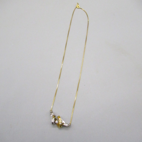 1 - 18ct yellow and white gold twisted pendant set with nine brilliant cut diamonds, on 18ct yellow gold... 