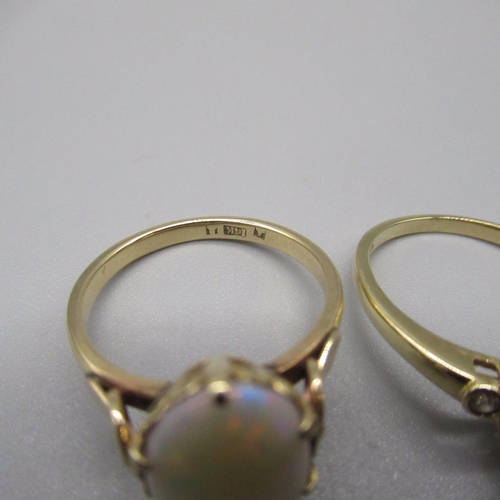 26 - 14ct yellow gold ring set with opal, stamped 14k, and a 14ct yellow gold ring set with pear cut purp... 