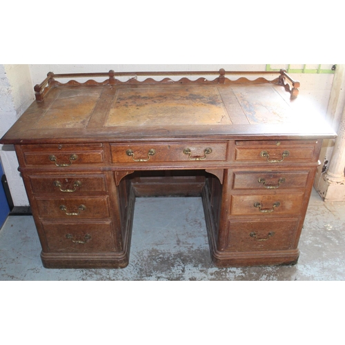 247 - Victorian panelled oak pedestal desk with galleried top, three frieze and six pedestal drawers with ... 