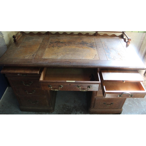 247 - Victorian panelled oak pedestal desk with galleried top, three frieze and six pedestal drawers with ... 