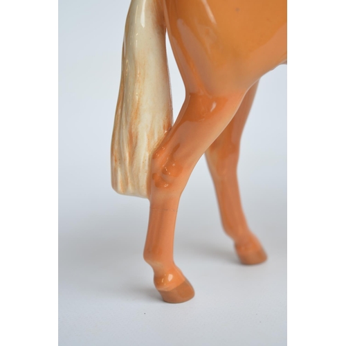 193 - Two Beswick Huntsman's Palomino and Palomino foal ceramic horse figurines, smaller Huntsman's with r... 