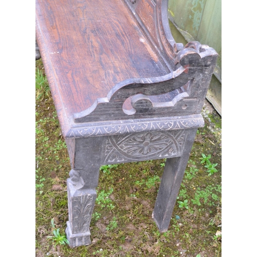 213 - Late C19th/early C20th oak hall bench with carved floral and swirl decoration. W122.5xH73xD34.5cm