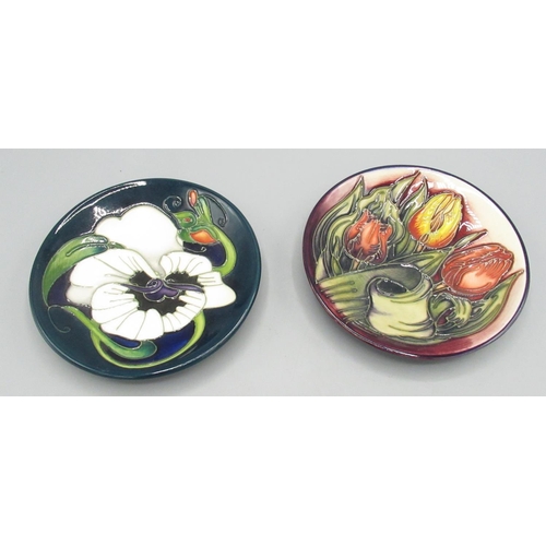 657 - Moorcroft Pottery: two trial pin dishes/coasters - tulip design by Emma Bossons, initialled EPB; and... 