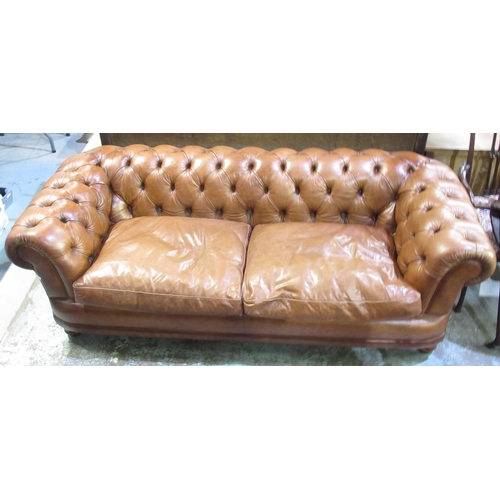 1265 - Chesterfield type sofa, upholstered in deep buttoned brown leather with loose seat cushion, W210cm D... 