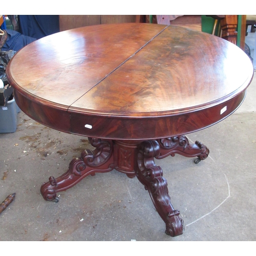 864 - Victorian figured mahogany extending dining table, circular pull action top with fold down legs on c... 