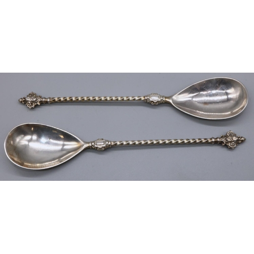 1096 - Pair of Continental silver serving spoons, with mask head terminals, barley twist handle and pear sh... 