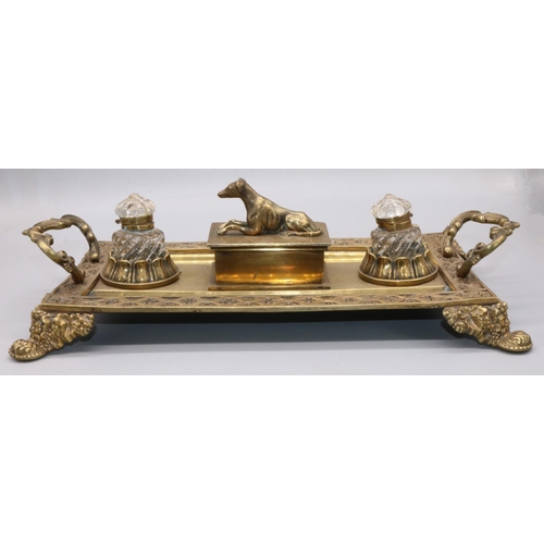 1145 - Victorian brass rectangular inkstand with gothic cast border and scroll handles, two glass wells and... 