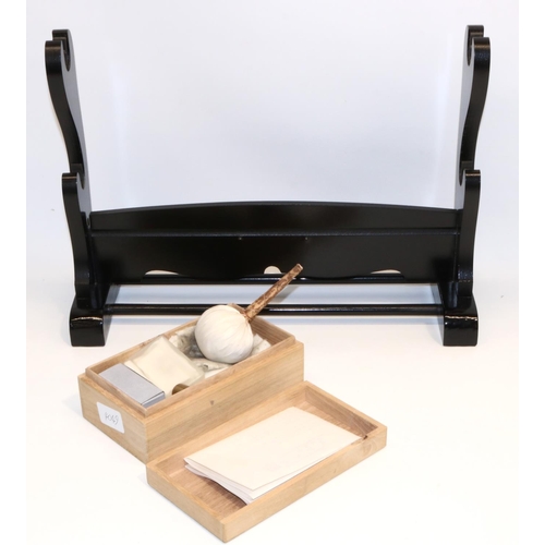 1229 - Boxed Japanese sword care kit and a two sword stand.