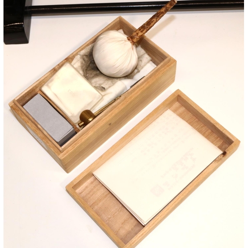 1229 - Boxed Japanese sword care kit and a two sword stand.