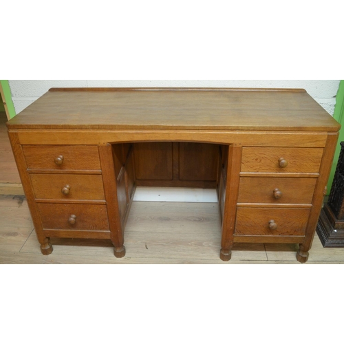 1482 - Robert Mouseman Thompson of Kilburn - an adzed oak panelled kneehole desk or dressing table, adzed t... 