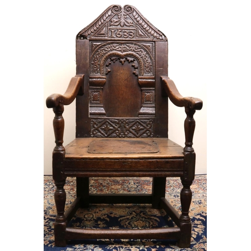 1408 - C17th style oak wainscot arm chair, arched panel back with scale carved angular top rail bearing dat... 