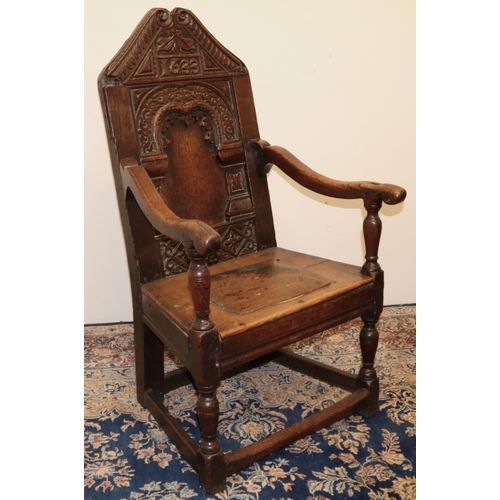 1408 - C17th style oak wainscot arm chair, arched panel back with scale carved angular top rail bearing dat... 