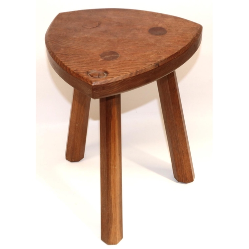 1487 - Alan Acornman Grainger, Acorn Industries Brandsby - an oak low stool, shaped triangular top on three... 