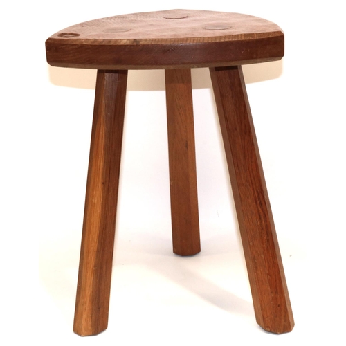 1487 - Alan Acornman Grainger, Acorn Industries Brandsby - an oak low stool, shaped triangular top on three... 