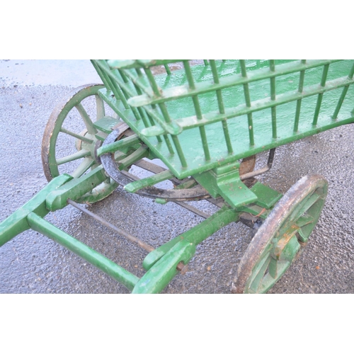 1497 - Early C20th green painted wooden Dog cart, spindle turned body with metal bound spoked wheels, W103c... 