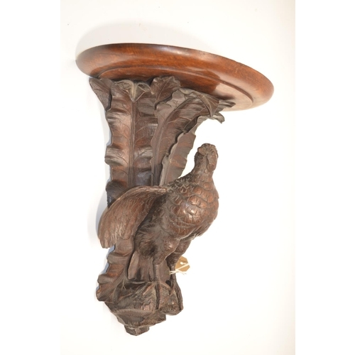 1149 - Black Forest style oak wall bracket, D shaped top on game bird support with leafage cresting, top, s... 