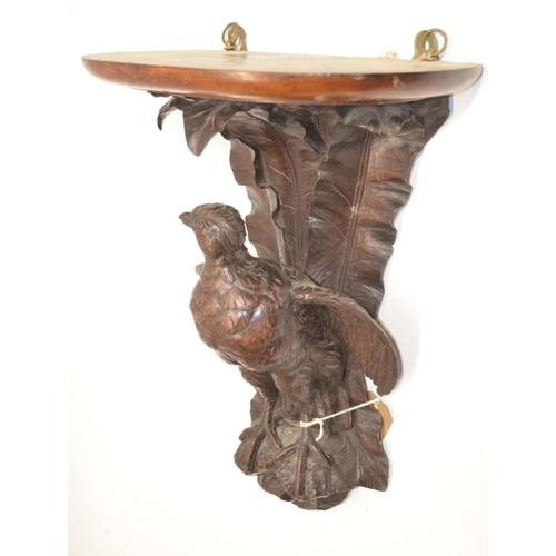 1149 - Black Forest style oak wall bracket, D shaped top on game bird support with leafage cresting, top, s... 