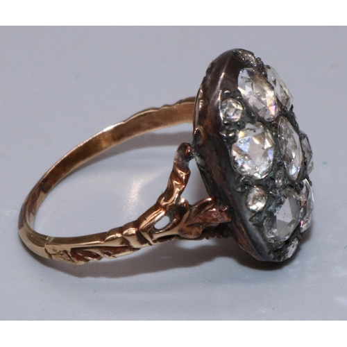 1005 - C18th yellow and white metal diamond cluster ring set with seven large old cut diamonds amongst eigh... 