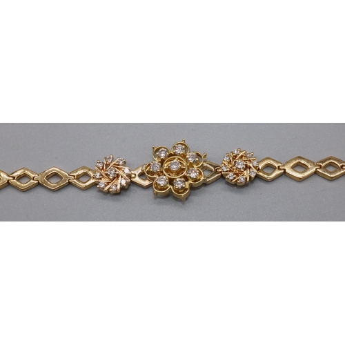 1026 - Yellow metal diamond cluster bracelet, the central floral cluster set with eight brilliant cut diamo... 