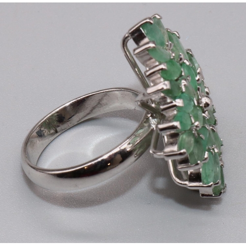 1027 - Silver cluster ring set with thirty two marquise cut emeralds in claw settings, on plain shank, stam... 