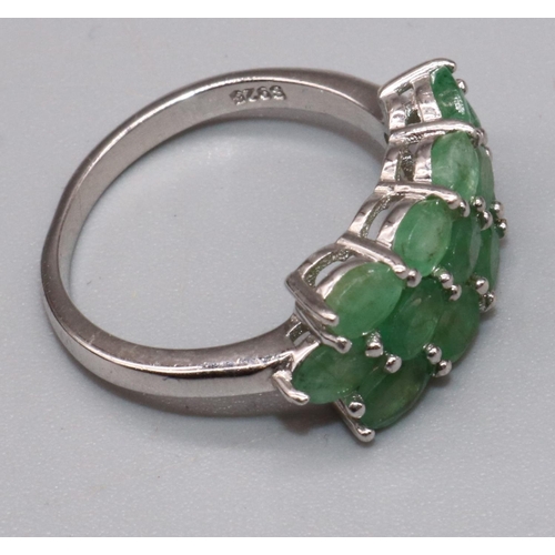 1022 - Silver cluster ring set with thirteen oval cut emeralds in claw settings, on plain shank, stamped 92... 
