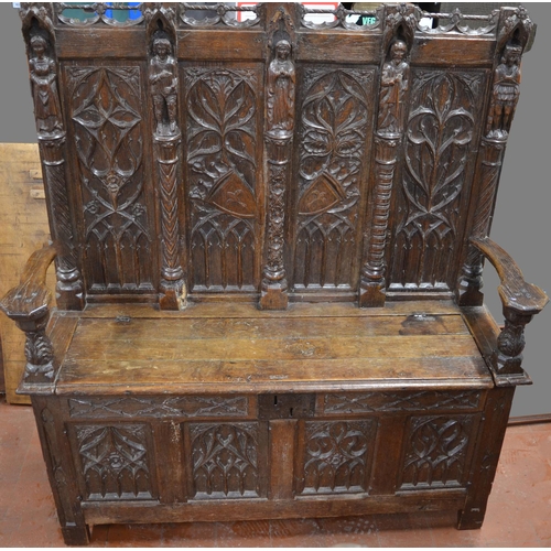 1404 - C17th and later oak box settle, raised back with pierced top rail, four gothic tracery carved panels... 