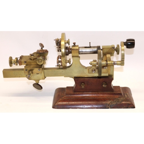 1258 - Victorian brass hand operated watchmakers' mandrel lathe, mounted on mahogany base together with acc... 