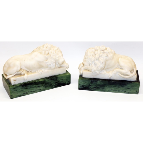 1124 - Pair of Grand Tour style white marble models of recumbent lions, on green marble rectangular plinths... 