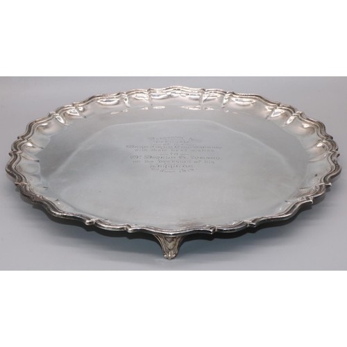 1076 - George V hallmarked silver circular salver with raised Chippendale style border, centre presentation... 