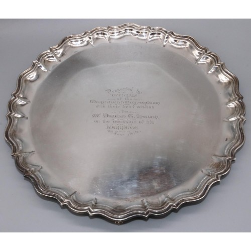 1076 - George V hallmarked silver circular salver with raised Chippendale style border, centre presentation... 