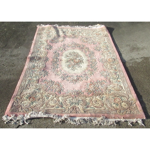 1316 - Salmon pink ground Chinese rug, oval wreath medallion centre in scroll border, 280cm x 180cm