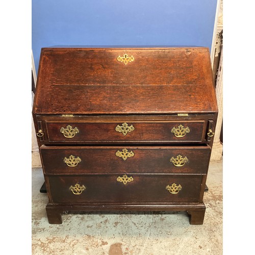 680 - Geo.111 oak bureau, slope fall front above three cock beaded drawers, brass swan neck handles on bra... 