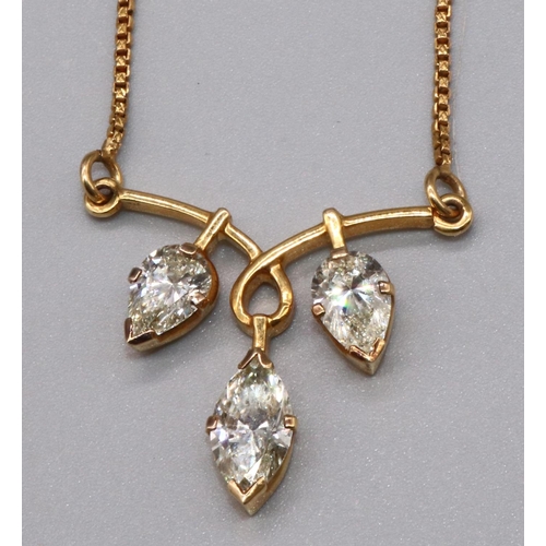 Yellow metal necklace with diamond centre piece, the central marquise cut diamond flanked by two pear cut diamonds, on yellow metal chain (A/F), 11.7g
