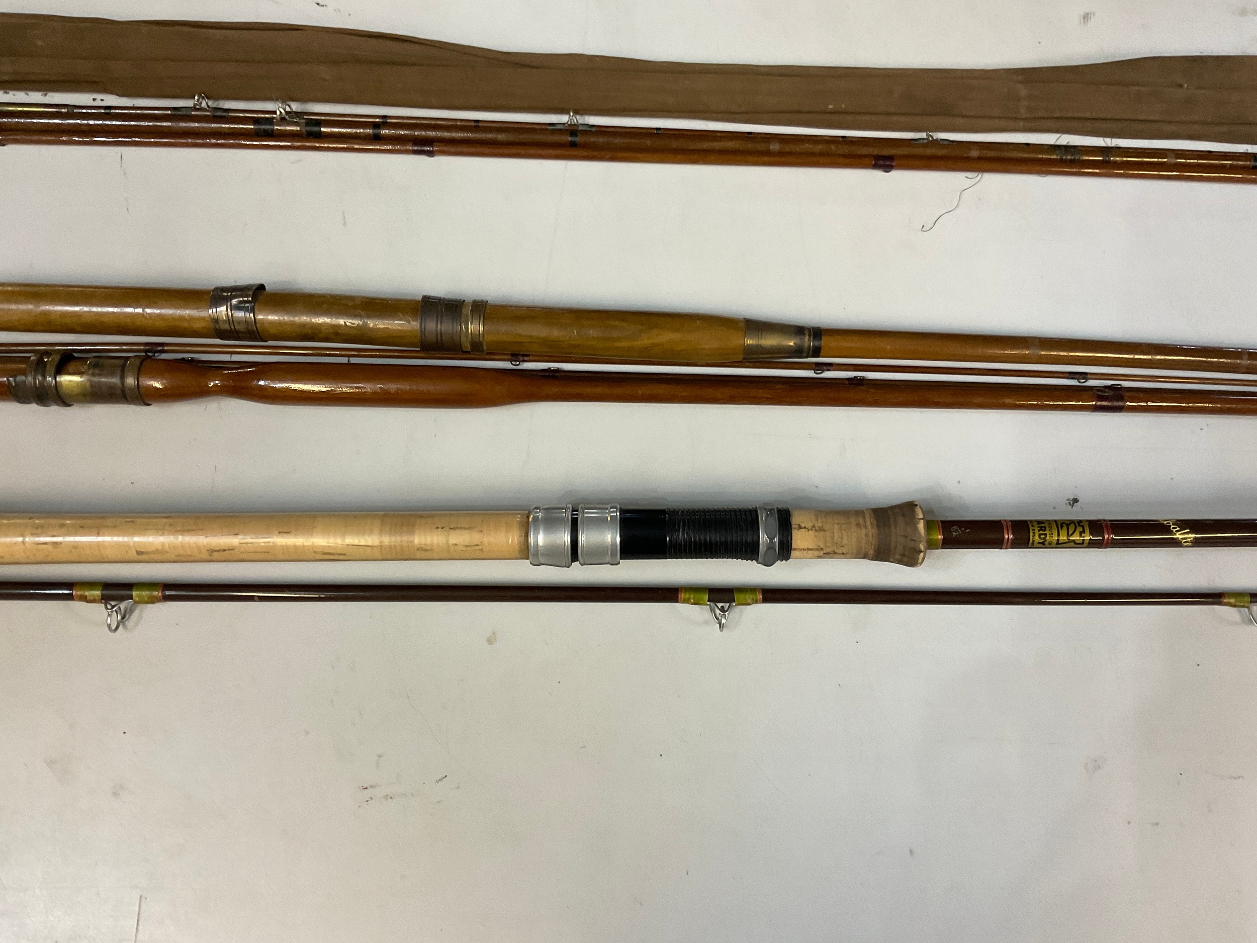 Three vintage fishing rods, one course and two fly, incl Hardy.