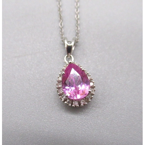 31 - 9ct white gold pendant set with teardrop cut pink stone surrounded by a halo of diamonds, on gold ch... 