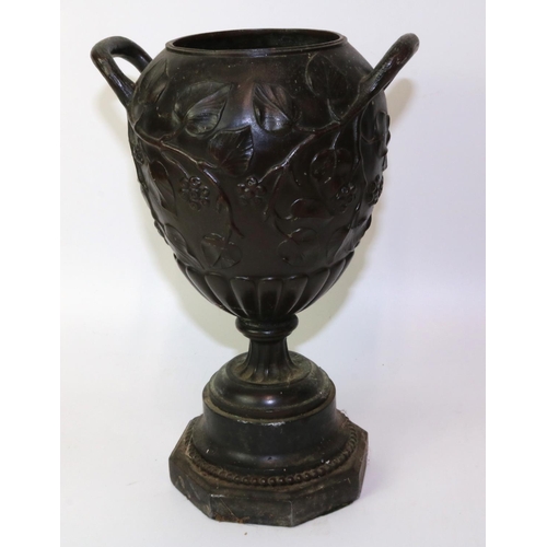 244 - C19th bronze twin handled urn, relief decorated with leaves and berries, H27.5cm