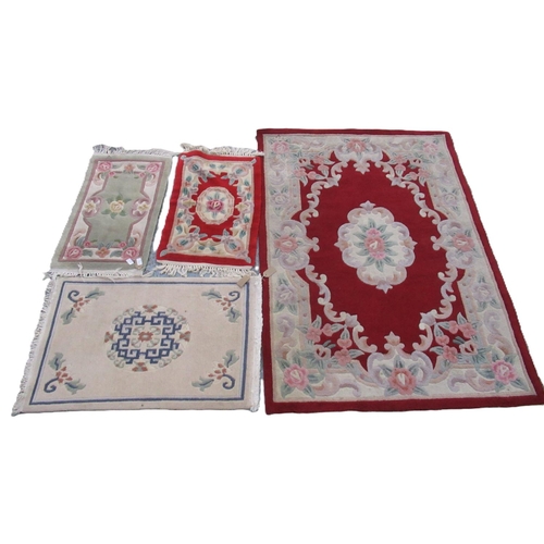 618 - Chinese red ground rug and three similar mats, 165cm x 119cm max (4)