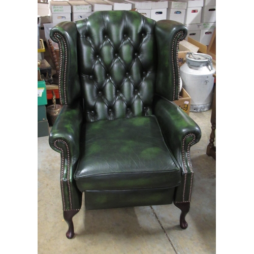 701 - Green leather wing back reclining chair, on cabriole legs, W79cm H110cm