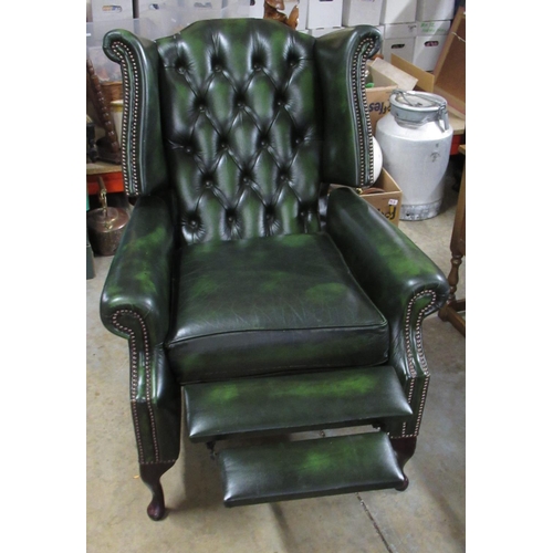 701 - Green leather wing back reclining chair, on cabriole legs, W79cm H110cm