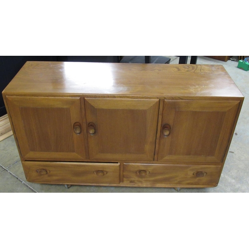 710 - Ercol Windsor light elm sideboard, with three doors and two doors with oval handles, on casters, W13... 