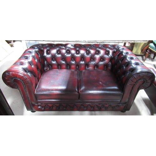 657 - Thomas Lloyd red leather upholstered two-seat Chesterfield sofa, deep buttoned back and arms with lo... 