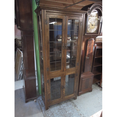 641 - Reproduction oak display cabinet with four doors and four adjustable shelves, W80cm D37cm H180cm