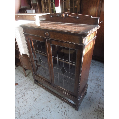 642 - C20th oak display cabinet, arched back and two lead glazed doors on turned supports with stretchers,... 