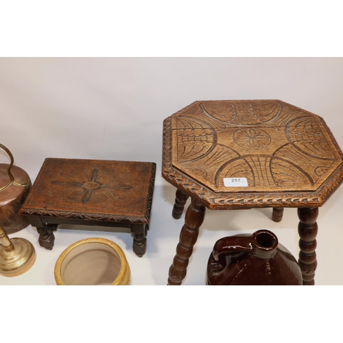 257 - Two oak stools with carved decoration to the tops, copper kettle, brass candlestick, stoneware flago... 