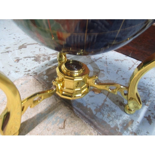 412 - Table top globe set with semi precious stones, on brass stand with inset compass, H34cm