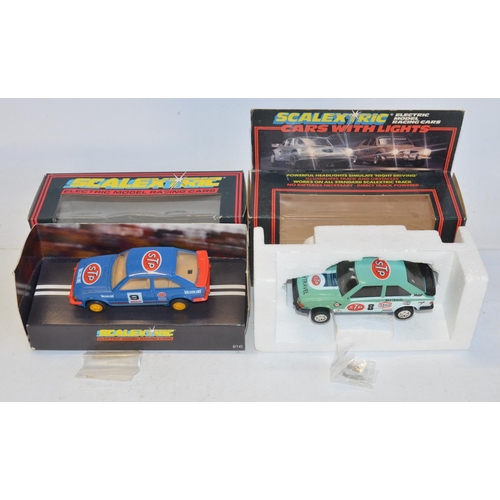 233 - Twelve vintage Scalextric slot cars to include C398 Red Mini (model mint), C399 Blue Mini (model min... 