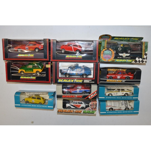 234 - Eleven vintage Scalextric slot car models to include C150 Red Mini Cooper (model mint, box good), C0... 