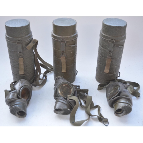575 - Three post war German gas mask cannisters with gas masks, no cartridges or spare lenses