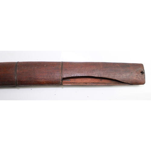 599 - Burmese Dha (sword) Wooden handle with copper hilt and brass pommel. The scabbard is made a split pi... 