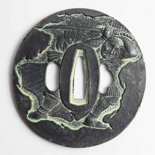 598 - Katana Tsuba. Made from iron depicting a warrior with Katana and Japanese script